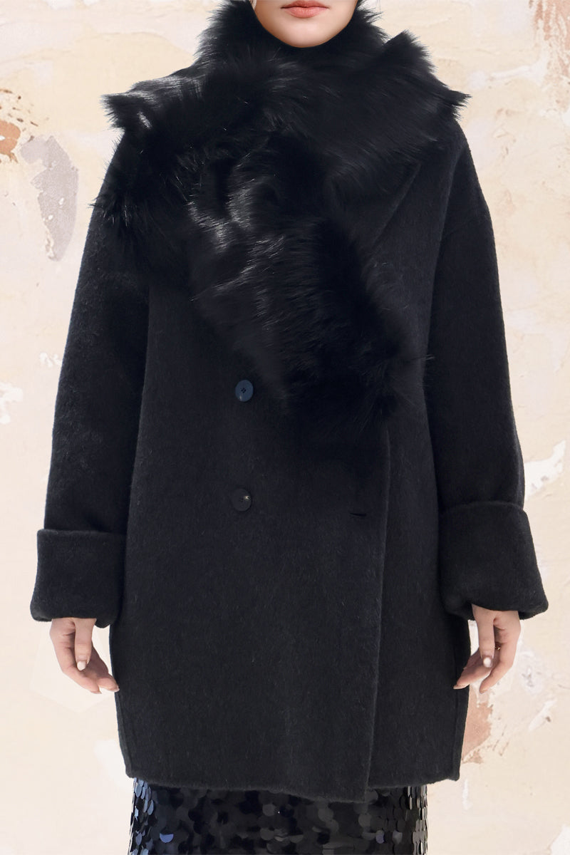 Model wearing Noir Luxe faux fur collar – soft black cross-wrap design