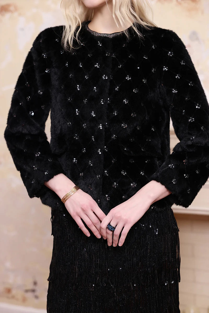Close-up of embellished wool coat, premium fabric detail and decorative embellishments