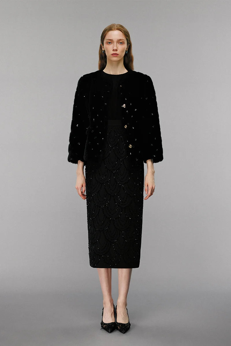 Model wearing embellished wool coat, elegant women’s outerwear