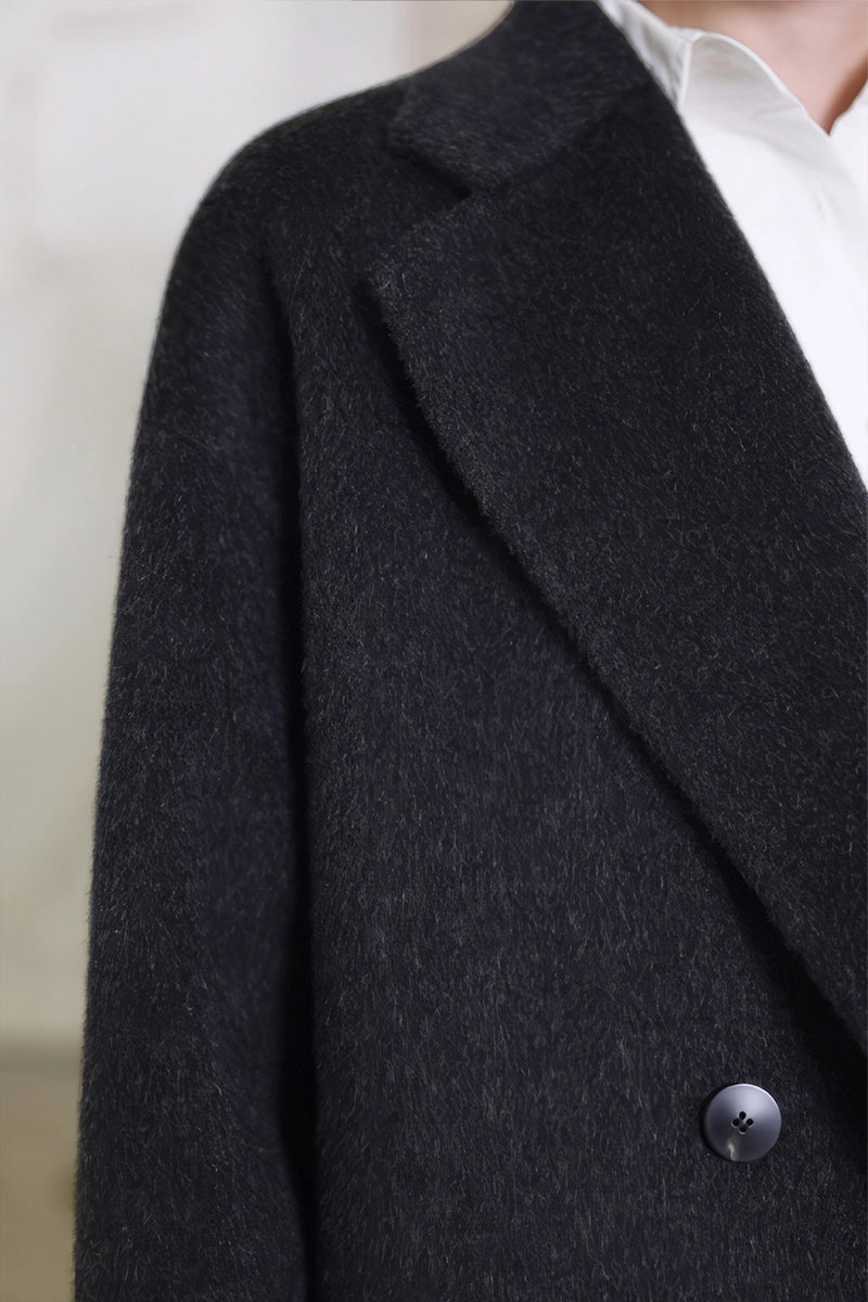 Close-up of buttons and camel wool fabric texture on Solelegia Coat