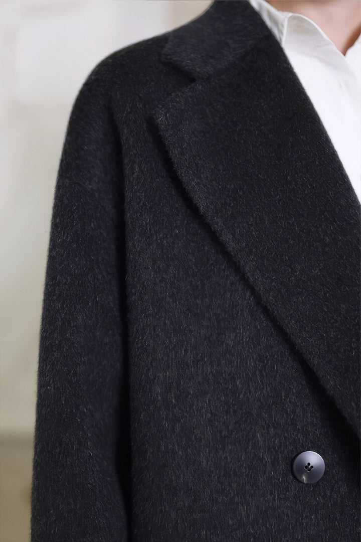 Close-up of buttons and camel wool fabric texture on Solelegia Coat