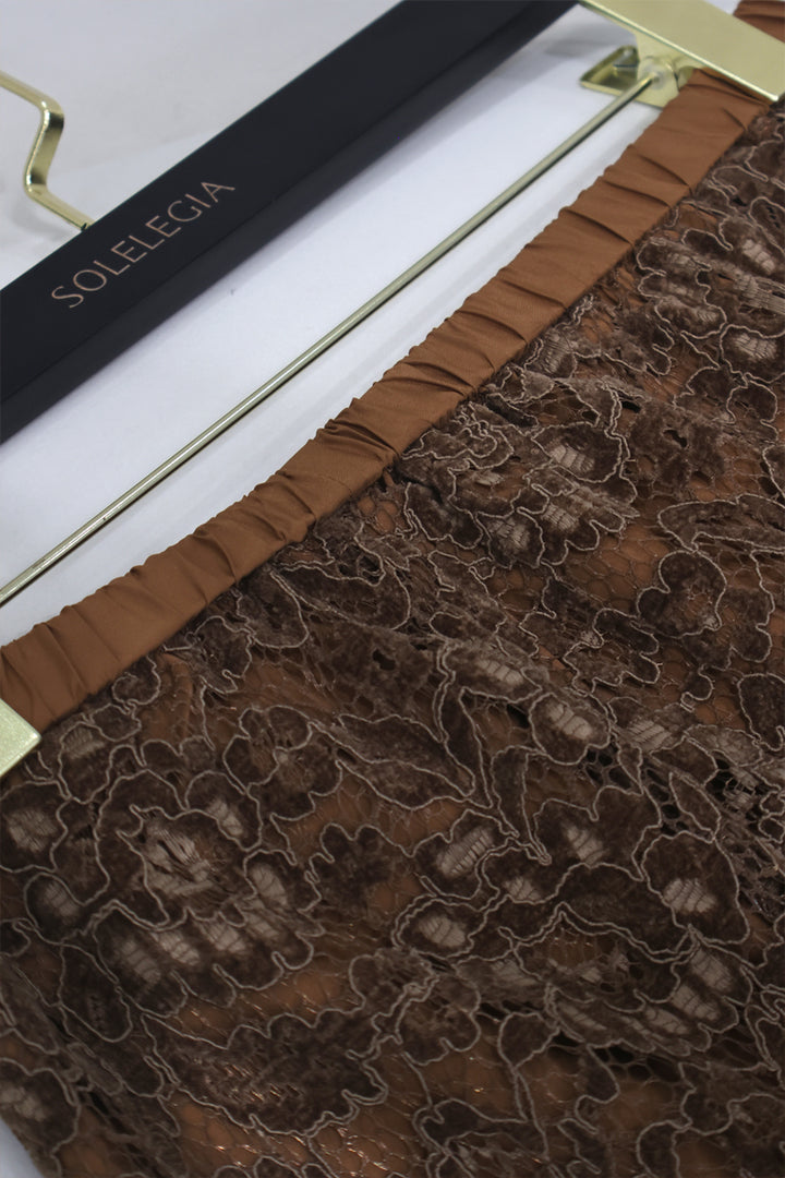 Close-up of delicate floral lace texture and scalloped hemline