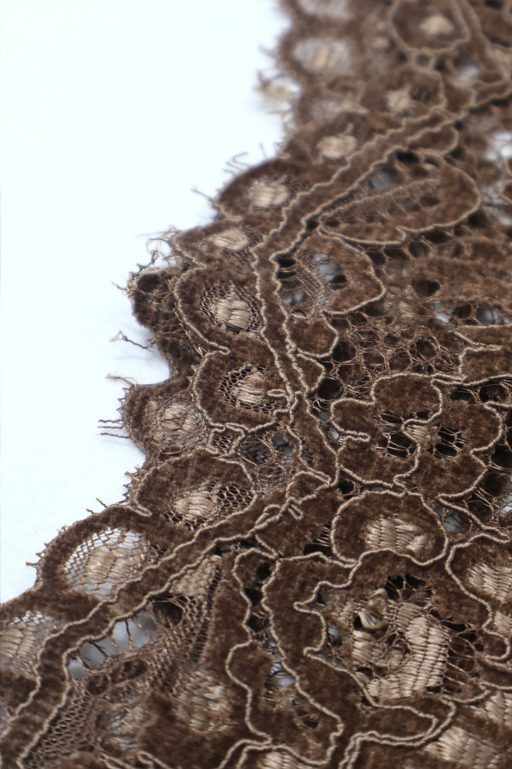 Close-up of delicate floral lace texture and scalloped hemline 