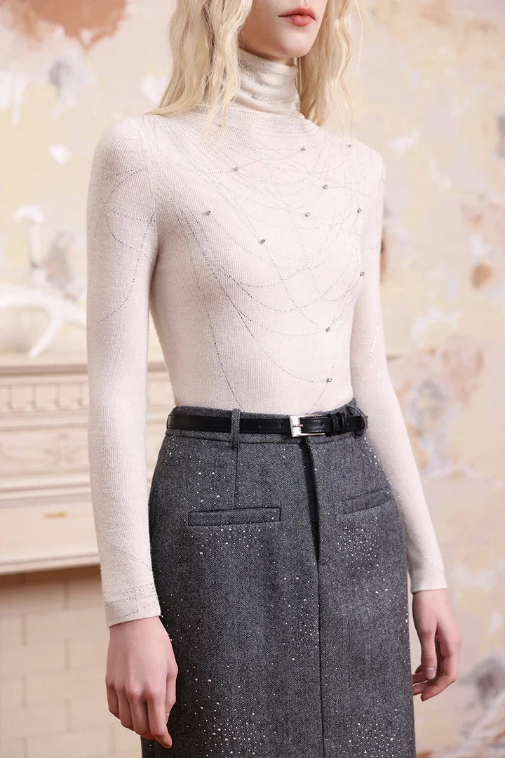 Close-up of Solelegia white sparkling embellished turtleneck knit top, rhinestone details and fine knit texture